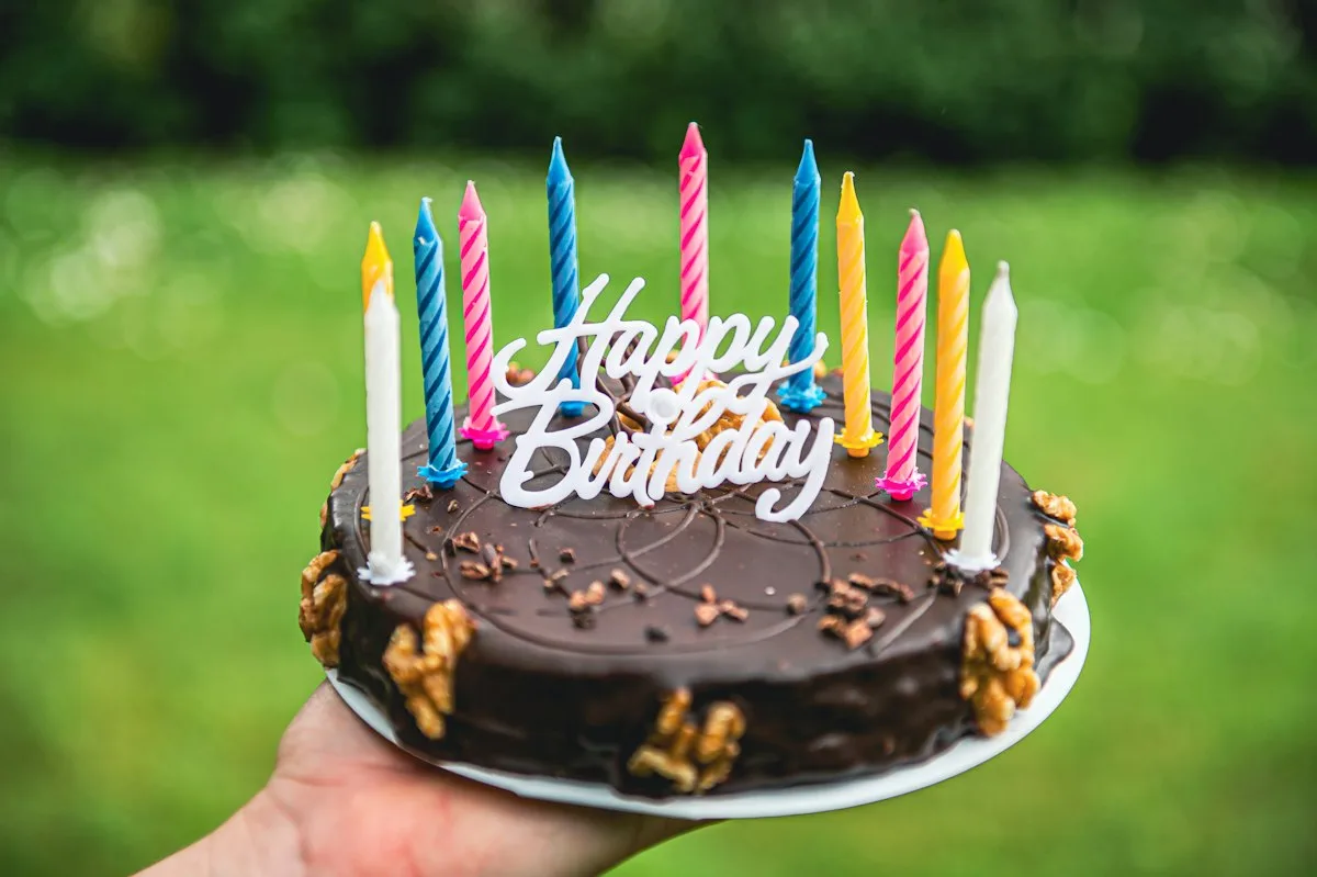 A birthday cake topped with lit candles