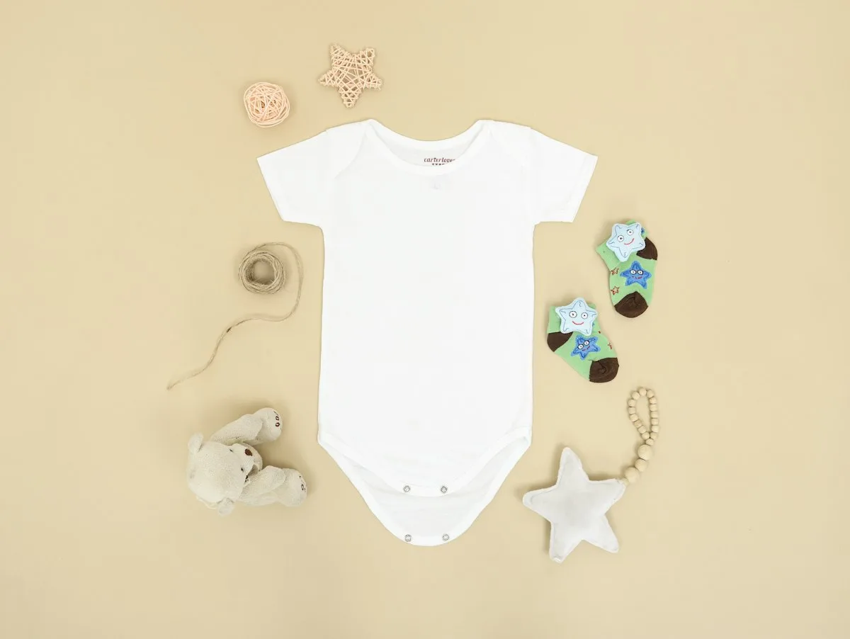 A small baby outfit laid out for a baby shower