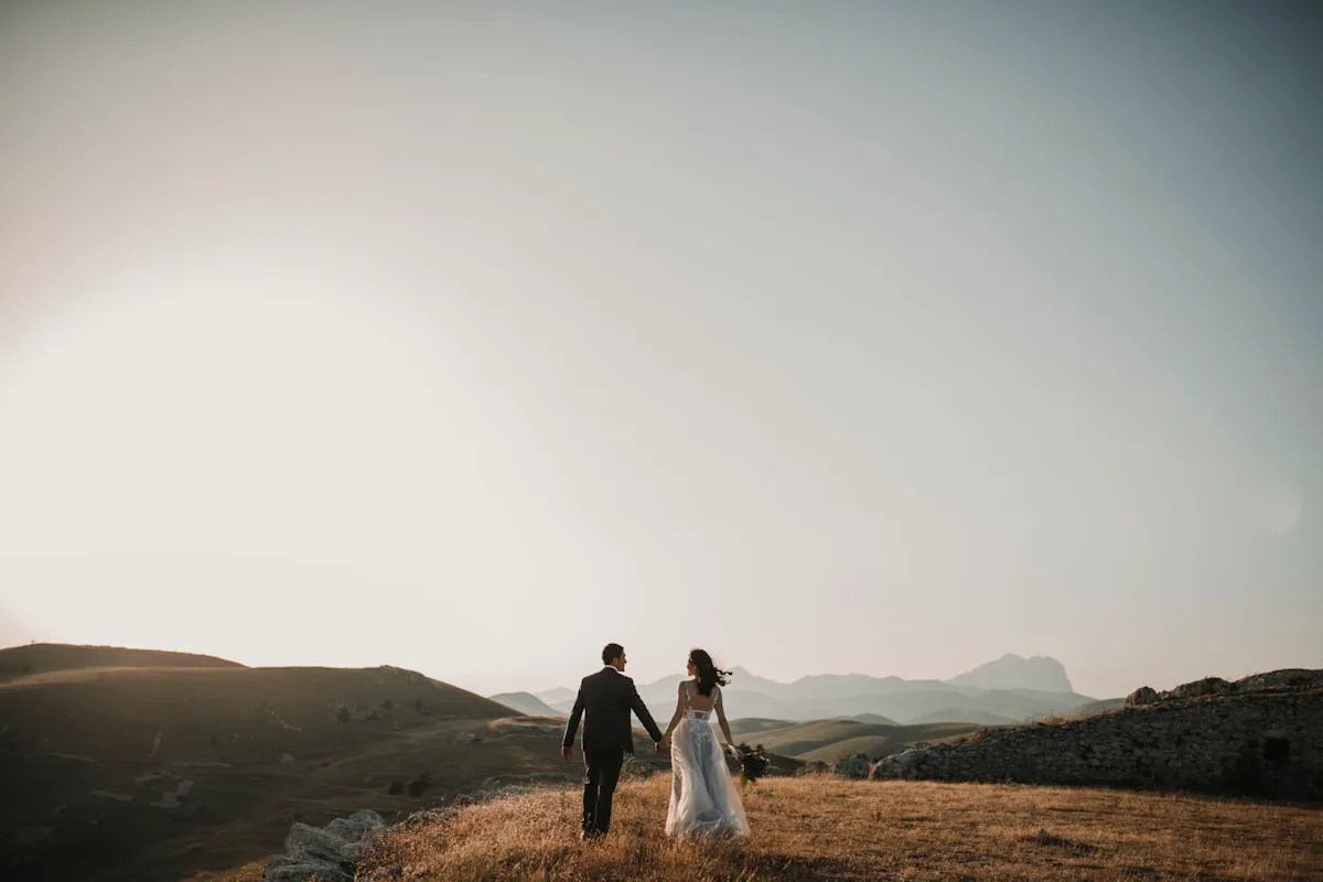 A couple walking together outdoors on their wedding day